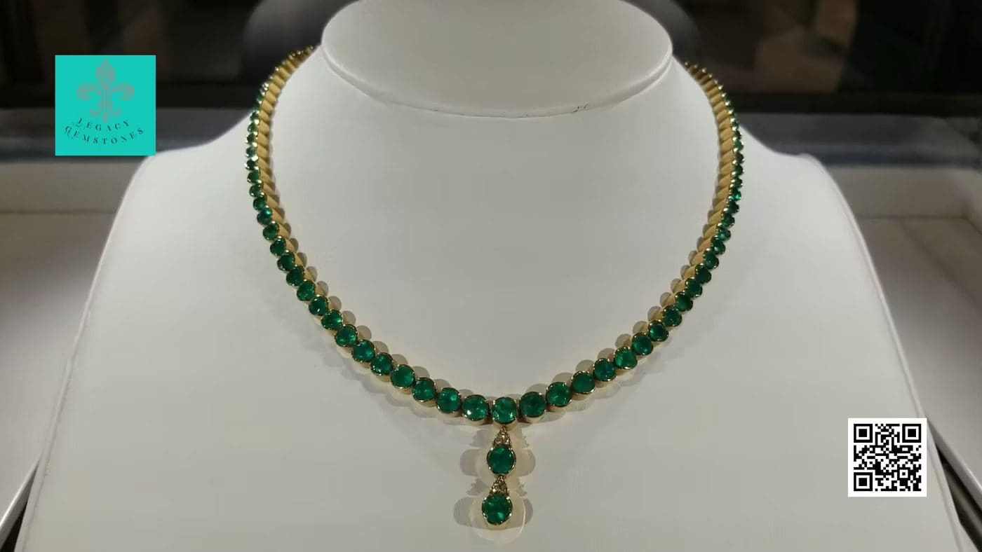 Elegant necklace with alternating green and gold beads displayed on a white bust, featuring a central green pendant, in a jewelry store setting with a qr code visible.