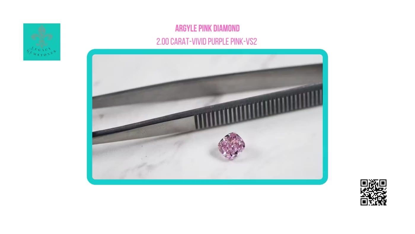 A rare 2ct , vivid purple-pink diamond displayed next to a pair of tweezers on a plain white surface, with a label describing it as a 2.00 carat argyle pink diamond.