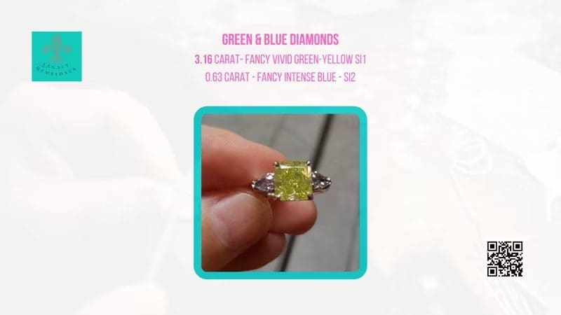 A person holding a ring with a 3.16-carat green-yellow diamond flanked by two smaller intense blue diamonds, against a blurred background with informational text and logos.