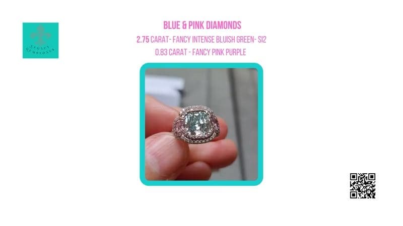 A close-up of a hand holding a diamond ring with a 2.75-carat blue diamond and 0.83-carat pink diamonds, against a promotional brochure background.