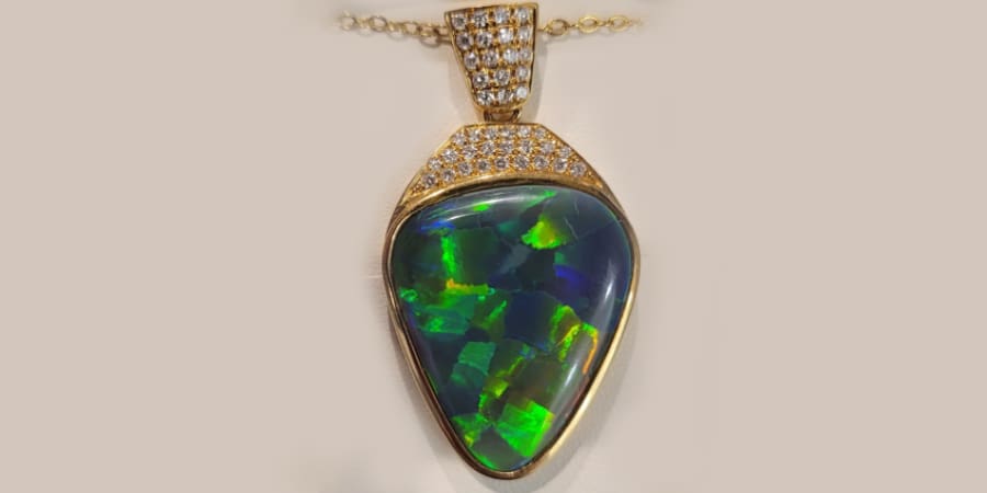 Fine jewellery featuring an Australian opal pendant with diamonds, showcasing unique jewellery design and legacy gemstones