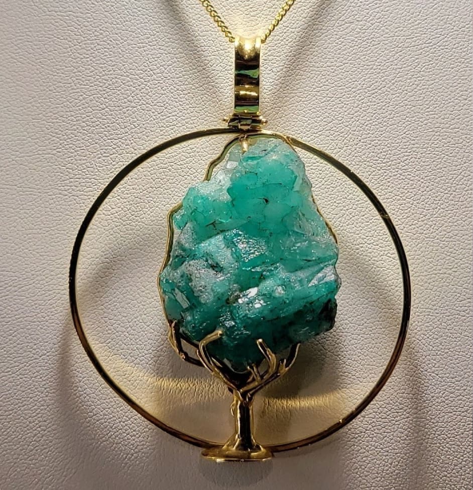 A one of a kind untreated rough emerald in the shape of a tree of life.